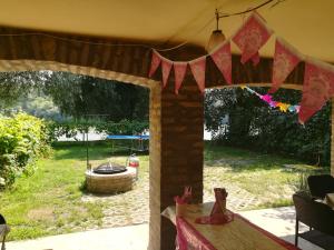 a view of a patio with a table and a yard at Tiszavirág Vendégház in Szeged