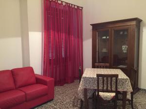 a living room with a red couch and a table at La Mariposa in Nova Siri +21 photos
