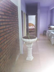 a white sink in a room next to a brick wall at San Miguel Hostal in Villarrica +60 photos