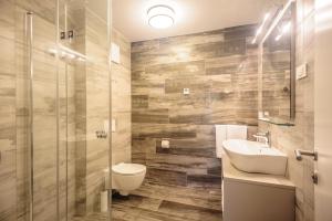 a bathroom with a toilet and a sink and a shower at Apartments Villa Tatiana in Bled