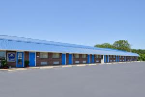 un edificio con puertas azules y aparcamiento en Americas Best Value Inn Sullivan, en Sullivan