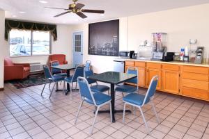a restaurant with tables and chairs and a kitchen at Americas Best Value Inn Sullivan in Sullivan