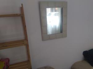 a mirror on the side of a wall in a room at Casa Roja in Las Palmas de Gran Canaria