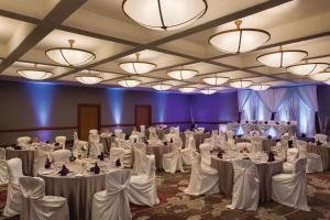 a banquet hall with white tables and chairs and chandeliers at Coast Edmonton Plaza Hotel by APA in Edmonton +37 photos