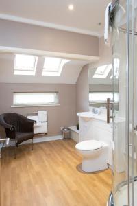 a bathroom with a toilet and a sink and skylights at Breckland Lodge in Attleborough +77 photos