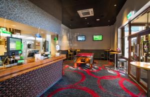 a bar with a pool table in a restaurant at Nightcap at Golden Beach Tavern in Caloundra