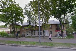 a woman walking in front of a building at Sweet Home Apartment in Kyiv