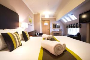 A bed or beds in a room at Breckland Lodge