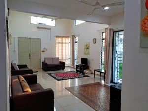 a living room with two couches and a tv at Siantan - Near Std Hang Jebat, Sg Udang & UITM Lendu in Melaka