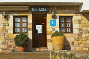 a building with a sign on the front of it at Hostería Miguel Angel in Santillana del Mar
