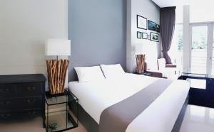 a bedroom with a large white bed and a window at The Midst@ Royal hills Nakornayok in Nakhon Nayok
