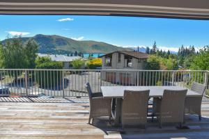 a patio with a table and chairs on a deck at Korokipo - Lake Tekapo in Lake Tekapo