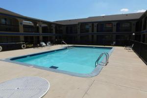 a large swimming pool in front of a building at Days Inn by Wyndham Oklahoma City NW Expressway in Warr Acres