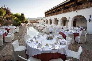 a table set up for a wedding with white tables and chairs at Parador de Guadalupe in Guadalupe