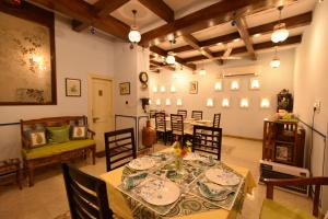 a dining room with a table and some chairs at Jaswant Niwas in Jodhpur