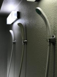 two handles on a wall in a bathroom at Fureai No Yado Yasuragi in Nozawa Onsen