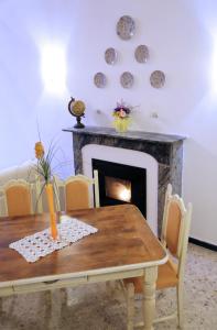 a dining room with a table and a fireplace at Casa Francesca Torre Saracena in Dolcedo