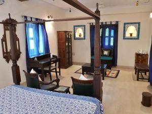 a bedroom with a bed and a piano in a room at Jaswant Niwas in Jodhpur