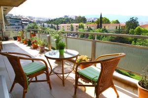 einen Balkon mit einem Tisch und Stühlen sowie Aussicht in der Unterkunft Astonishing view in Athen