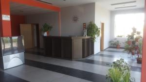 an empty lobby with a reception desk and potted plants at Hotel Seasons 2 in Sunny Beach