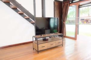 a flat screen tv sitting on a stand in a living room at Salisa Resort in Ko Lipe