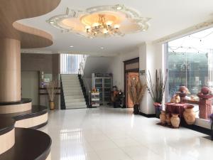 a lobby with a chandelier and a staircase at Leelawadee Grand Hotel in Udon Thani