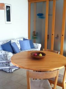 uma mesa de madeira com uma taça de fruta em cima em The Dina Palace. em Villefranche-sur-Mer