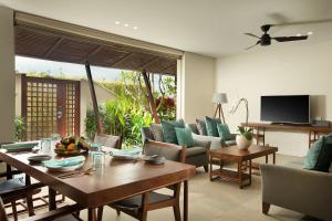 a living room with a table and chairs at The Tamarind Resort - Nusa Lembongan in Nusa Lembongan