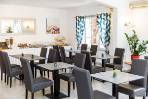 a restaurant with tables and chairs in a room at Hôtel Les Liserons de Mougins in Mougins