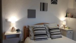 a bedroom with a bed with two night stands and two lamps at Le Domaine des Terres Blanches in Le Boulvé