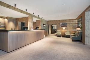 a hotel lobby with a reception desk and chairs at Thon PartnerHotel Jølster in Skei