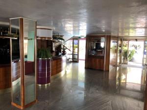 a large room with a kitchen and a lobby at Hotel Flamingo in Rimini