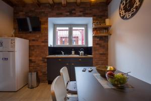 a kitchen with a table with a bowl of fruit on it at Guest House Blue in Zadar