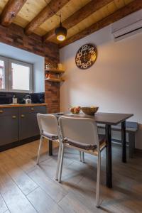 a kitchen and dining room with a table and chairs at Guest House Blue in Zadar