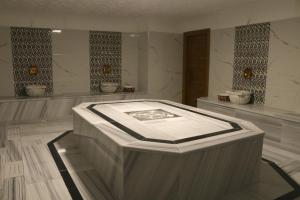a large room with a large tub in the middle at Business Grand Hotel in Ankara +78 photos