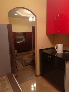 a kitchen with red cabinets and a black counter top at Jermuk Apartment in Jermuk +41 photos
