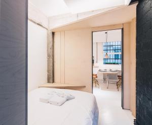 a bedroom with a bed and a dining room at Kaia Apartment by People Rentals in Bilbao