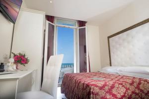 Postel nebo postele na pokoji v ubytování Hotel Lido