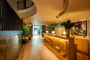 a lobby with a bar with plants in it at Chic & Basic Velvet in Barcelona