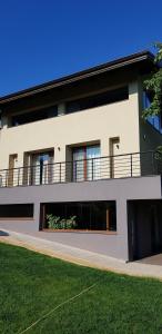 a large white building with a balcony on it at Mihaylova kushta in Lyubosh