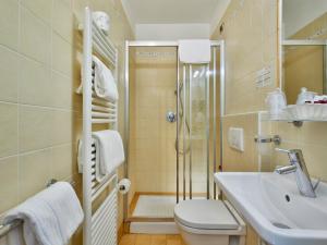 a bathroom with a shower and a toilet and a sink at Hotel Centrale in Cernobbio