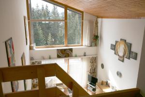 a staircase in a house with a large window at I dr Rehwiesa A32 in Arosa