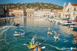 a group of people in boats on a river at Sète&Toi in Sète