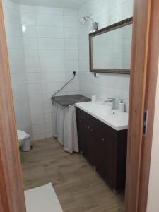 a bathroom with a sink and a mirror at Apartament Centrum in Mikołajki