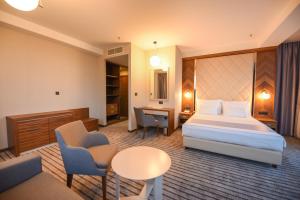 a hotel room with a bed and a desk at Hotel Union in Podgorica