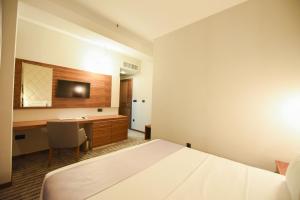 a hotel room with a bed and a desk at Hotel Union in Podgorica