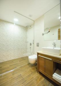 a bathroom with a sink and a toilet at Hotel Union in Podgorica