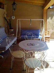 a patio with a table and chairs and a couch at Hansel y Gretel in Pedrosa del Rey