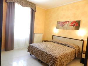 a bedroom with a bed and a large window at Hotel Air Palace Lingotto in Turin +67 photos
