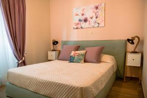 a bedroom with a bed with pink walls at Traditional Thiseio Home in Athens